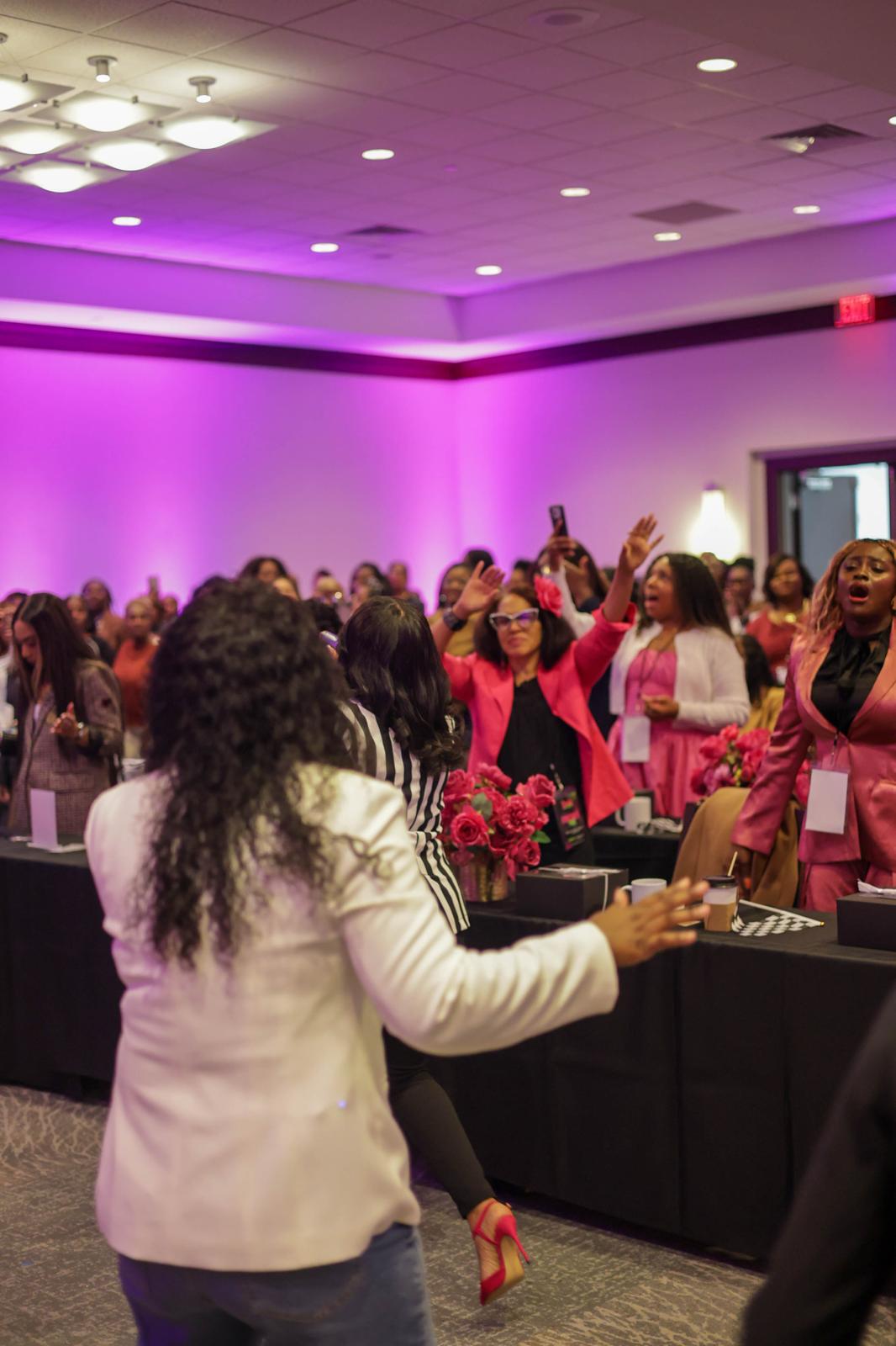 Women joining together in the conference ballroom