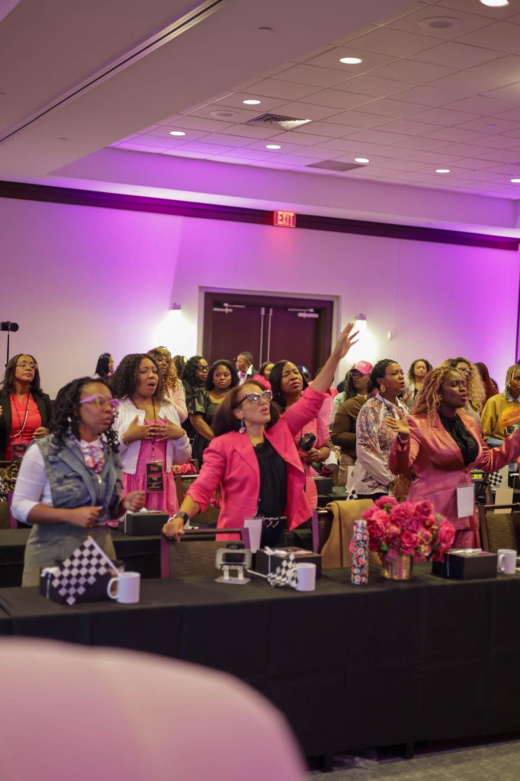 Women participating in the conference around banquet tables